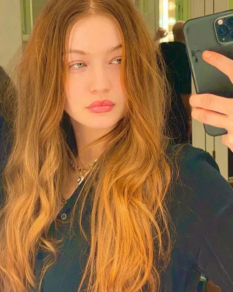 A woman in black dress posing for selfie and showing her Ginger Orange hair color A woman in black dress posing for selfie and showing her Ginger Orange hair color - red hair color 2022