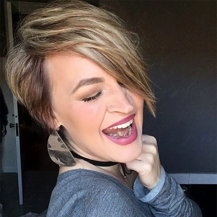 Smiling woman in blue top and Chopped Pixie hairstyle Smiling woman in blue top and Chopped Pixie hairstyle - hairstyle 2022 female