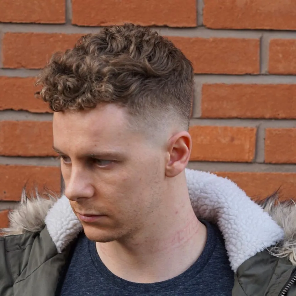 A man in greenish fur jacket with t-shirt posing for camera and showing his Caesar Cut A man in greenish fur jacket with t-shirt posing for camera and showing his Caesar Cut - Short Hairstyle for Men