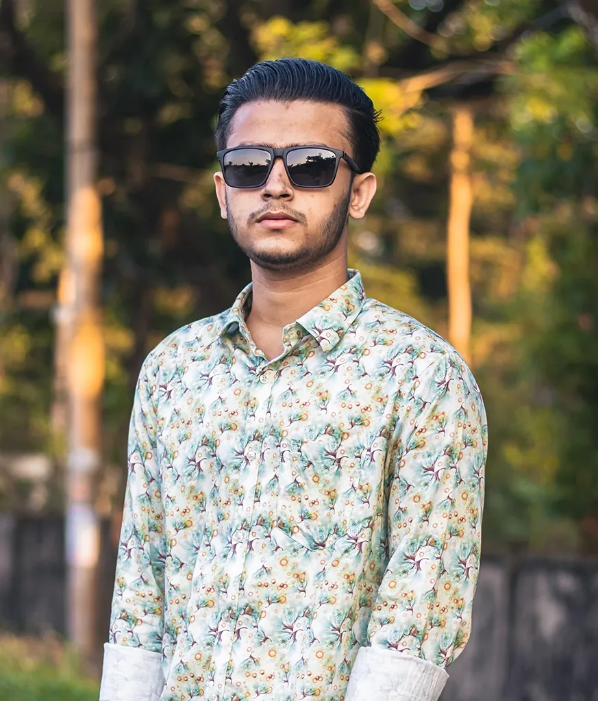 Boy in multicolor printed shirt and goggles with combed and gelled look Boy in multicolor printed shirt and goggles with combed and gelled look - Indian hairstyle boy simple