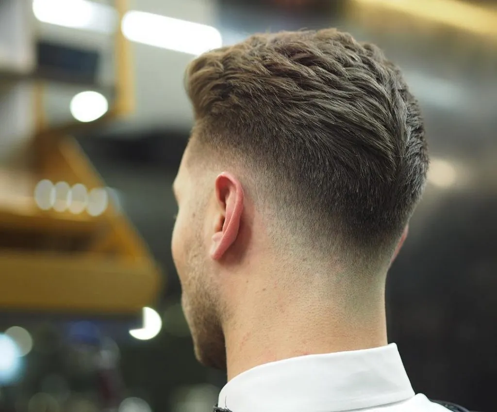 A man in white shirt showing his LowFade UnderCut form back side A man in white shirt showing his LowFade UnderCut form back side - Short Hairstyle for Men