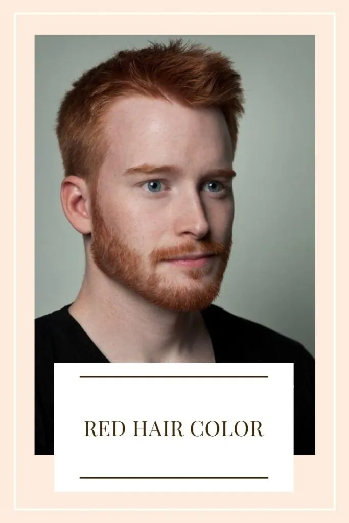 A boy in black t-shirt showing his red hair A boy in black t-shirt showing his red hair - trending hair color for men