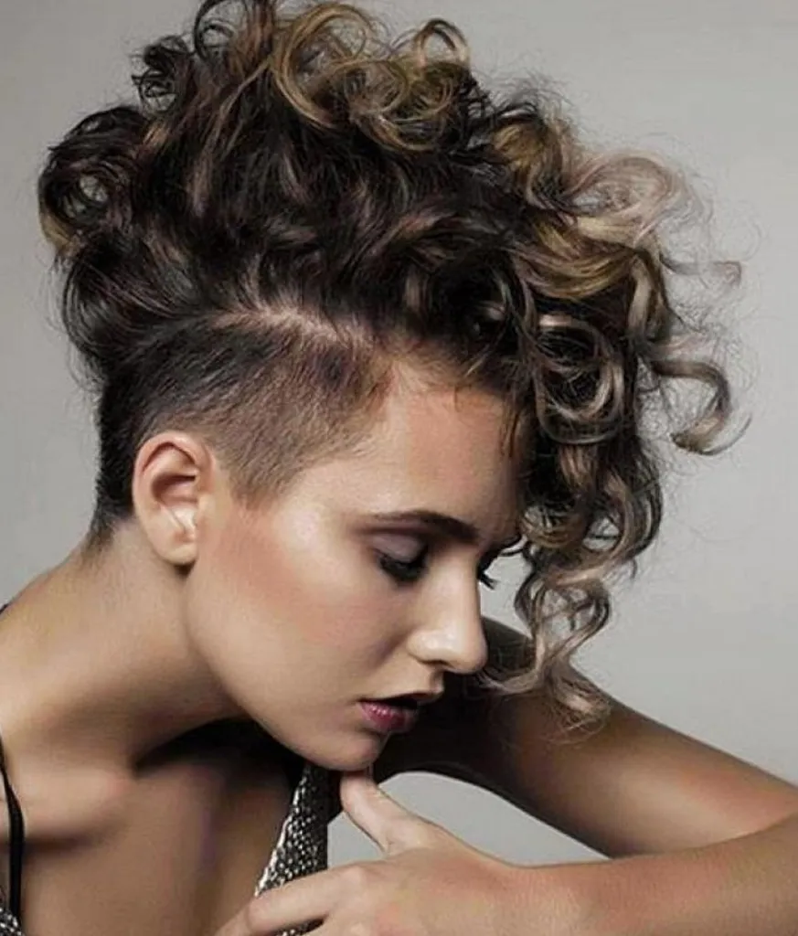 Woman in silver strappy dress and Curly Mohawk hairstyle Woman in silver strappy dress and Curly Mohawk hairstyle -