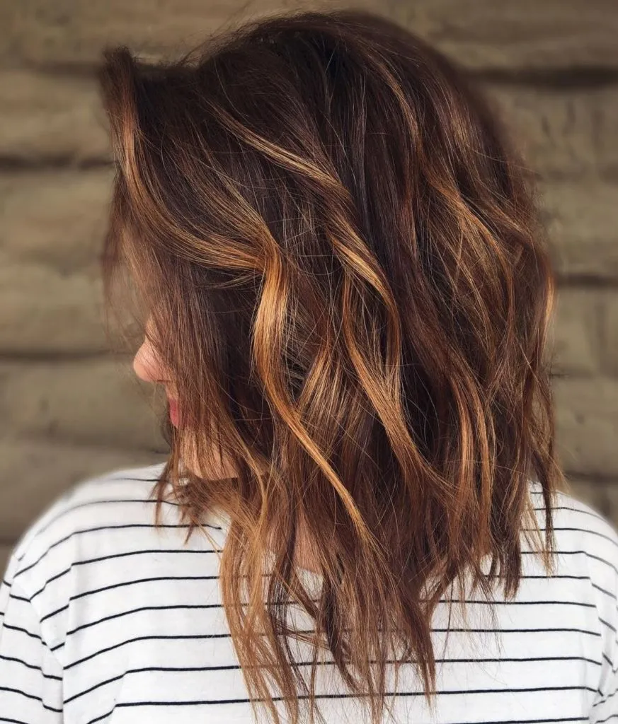 Woman in black and white lining t-shirt and Lob hairstyle with Warm Highlights Woman in black and white lining t-shirt and Lob hairstyle with Warm Highlights