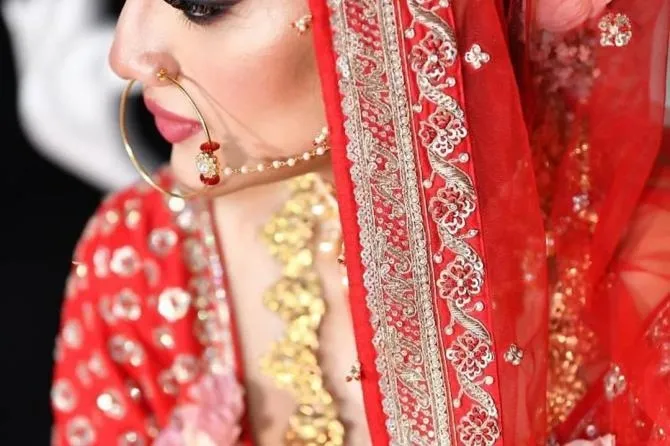 Nusrat Jahan posing as a bride in a traditional red dress Nusrat Jahan posing as a bride