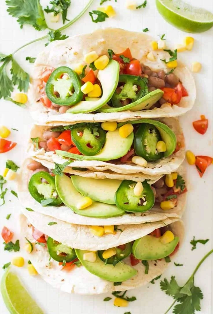 Plate of vegan pinto bean tacos - vegetarian breakfast ideas for bodybuilding Plate of vegan pinto bean tacos - vegetarian breakfast ideas for bodybuilding