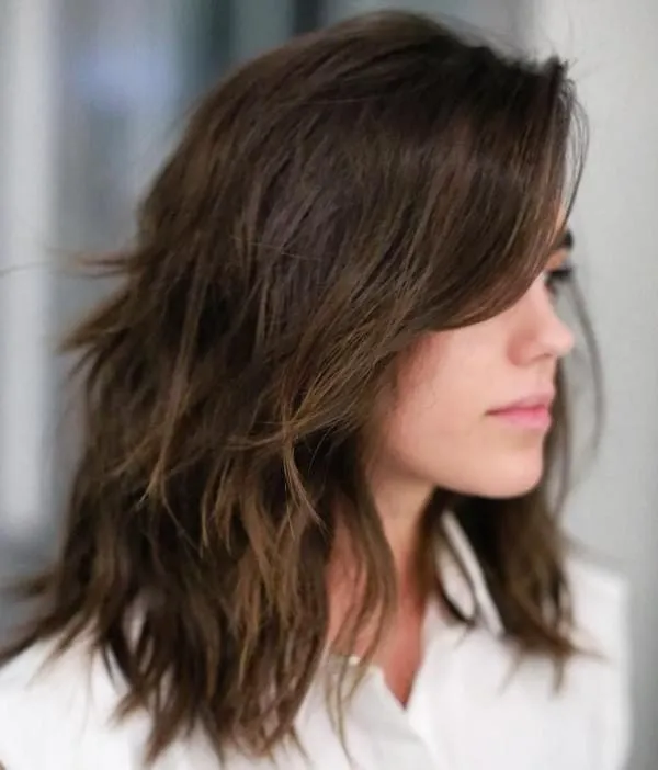 Woman in white shirt showing the side view of her The updated shag hairstyle Woman in white shirt showing the side view of her The updated shag hairstyle - hairstyle 2022 female