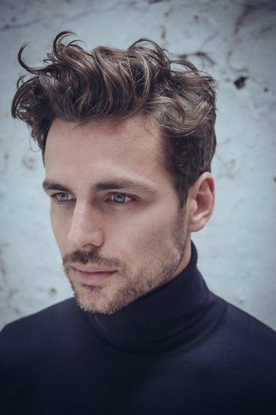 Man in black high neck sweater and Curly on Top - haircuts for men with long hair