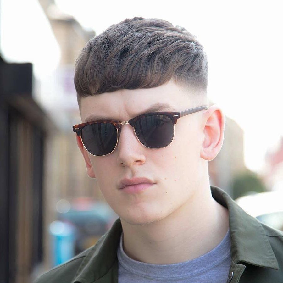 Man in grey jacket with sky blue t-shirt and goggles - mens haircuts list