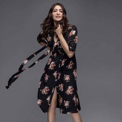 Anushka Sharma in black and pink floral knee length dress posing for camera - Most Beautiful Indian Girl