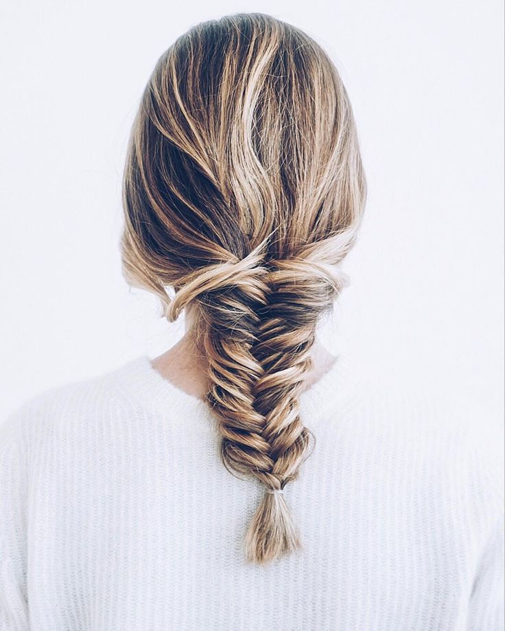 A woman in white sweater showing her Back Dutch Braid - hairstyles for girls with medium hair