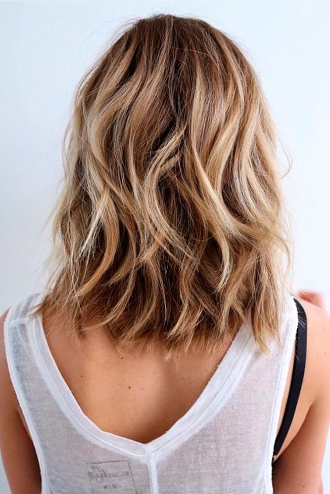 Woman in white sleeve less top and Beach Style hairstyles - hairstyles for medium hair indian