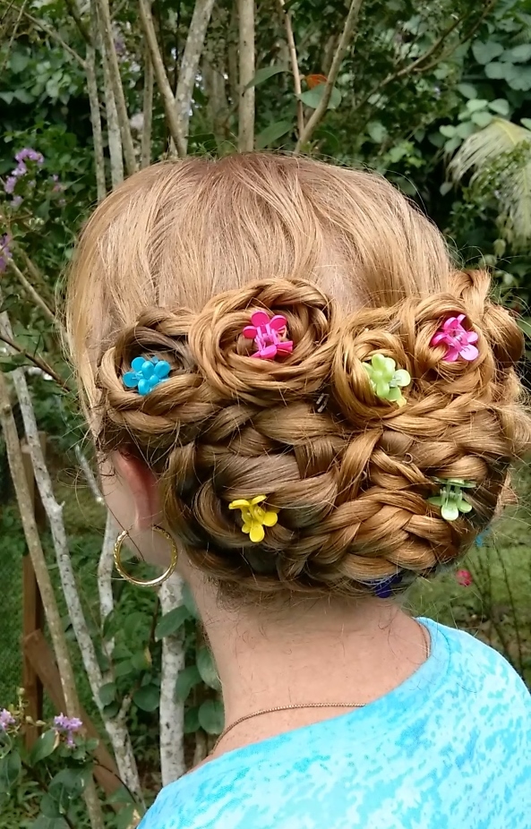 A girl in greenish t-shirt showing the back view of her Bouquet Bun - wedding hairstyles