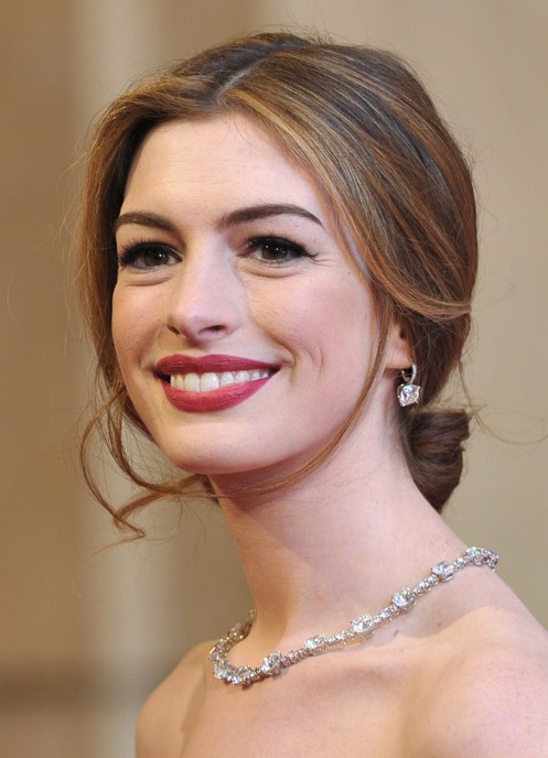 A woman in off shoulder dress with a necklace and earrings showing her Center Parted Updo - hairstyles for women