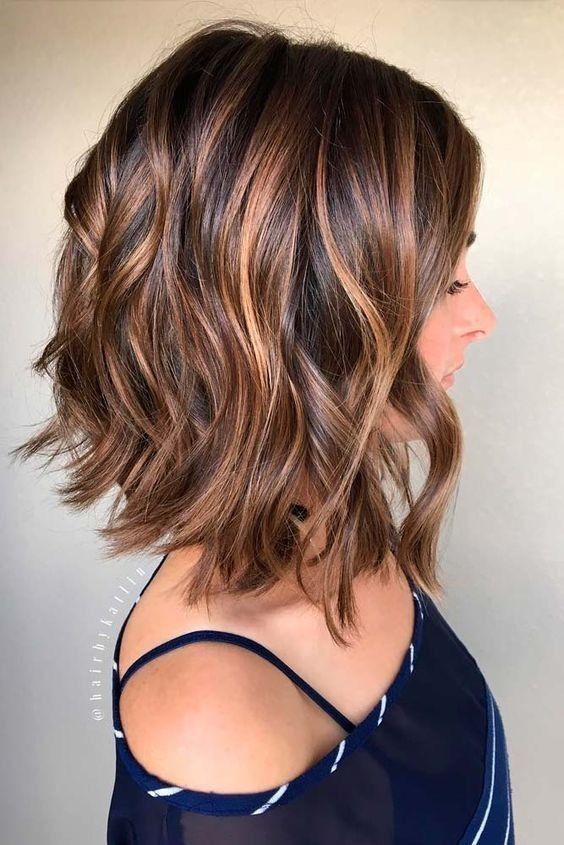 A woman in  blue boat neck top and0 Chocolate Wave hairstyles - hairstyles for medium hair for party