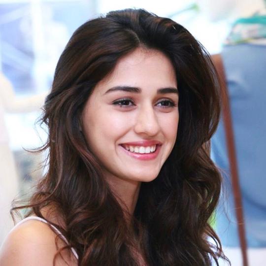 Smiling Disha Patani in white strappy dress posing for camera - Most Beautiful Indian Girl