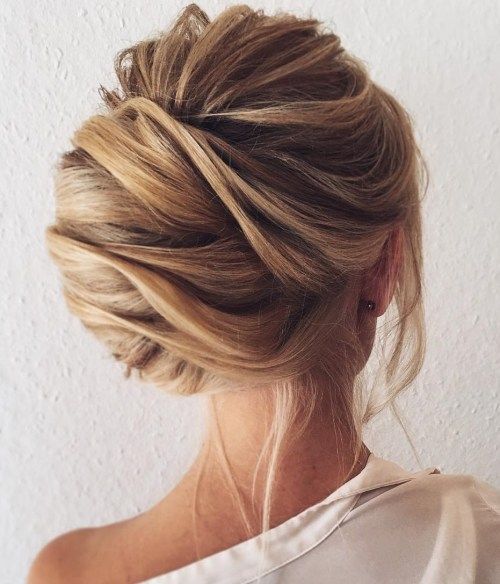 A girl in white shirt showing the back view of her French Twist Bun - bun hairstyles