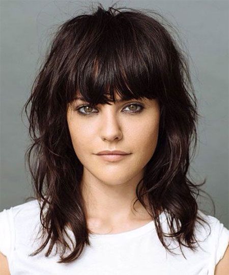 A woman in white cut sleeves top and Heavy Fringe Hairstyles - hairstyles for ladies medium length