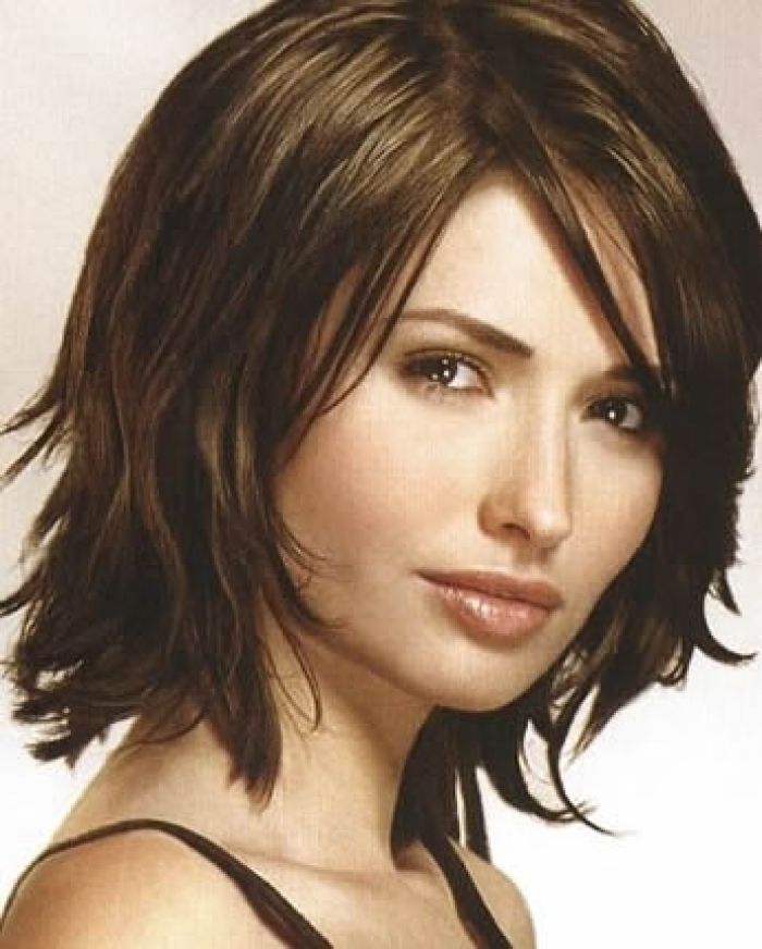Woman in black strappy dress and Layered Sassy Hairstyle - hairstyles for medium hair for party