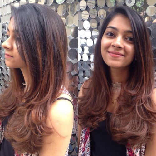 Smiling woman in black tank top with multicolor scarf and Layered With Balayage - haircut for straight hair oval face