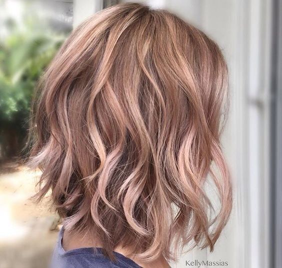 A woman in blue t-shirt showing the side view of her Light Soft Sass Look Hairstyles -  haircut for medium hair girl