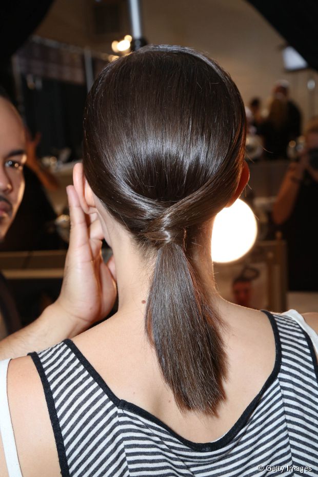 woman in black and white strappy tank top showing the back vie of her Low Ponytail Hairstyles for Girls with Medium Hair - hairstyles cut for long hair