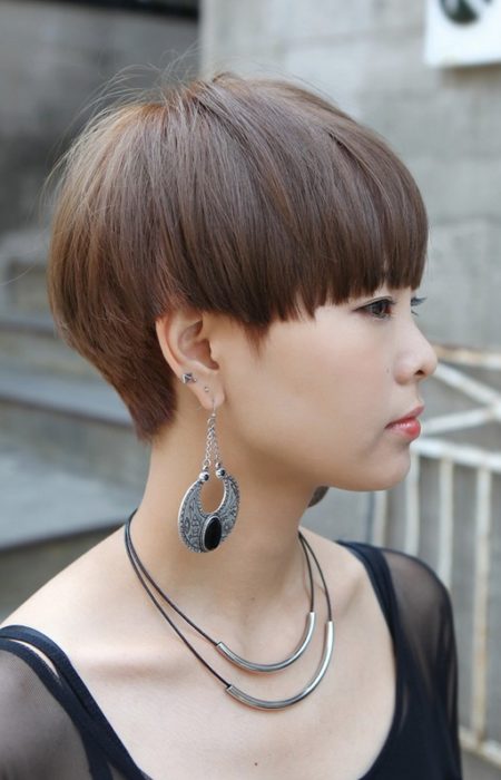 Woman in black round neck net dress with  mushroom Cut Hairstyle - simple hairstyles for dresses