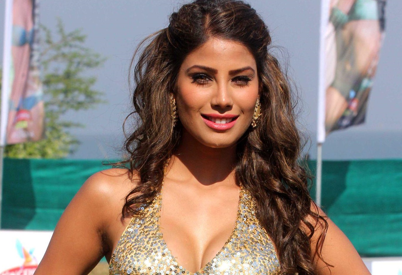 Nicole Faria in golden sequence top posing for camera - most beautiful Indian girl