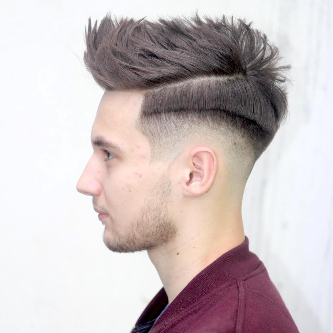 A boy in maroon t-shirt is showing his Pomp Fade hairstyle - Hairstyles for Boys