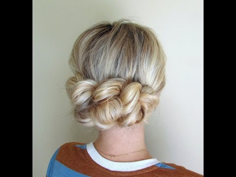 A girl in multicolor t-shirt showing the back view of her Pull through braid - bun hairstyles