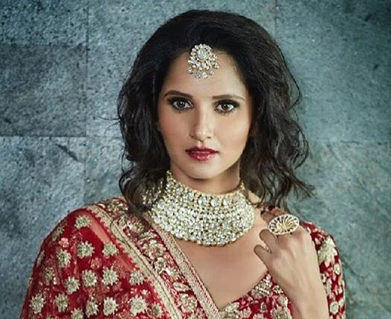 A girl in red traditional dress and heavy jewellery showing her Shaggy Faux Bob - Hairstyles for indian Wedding
