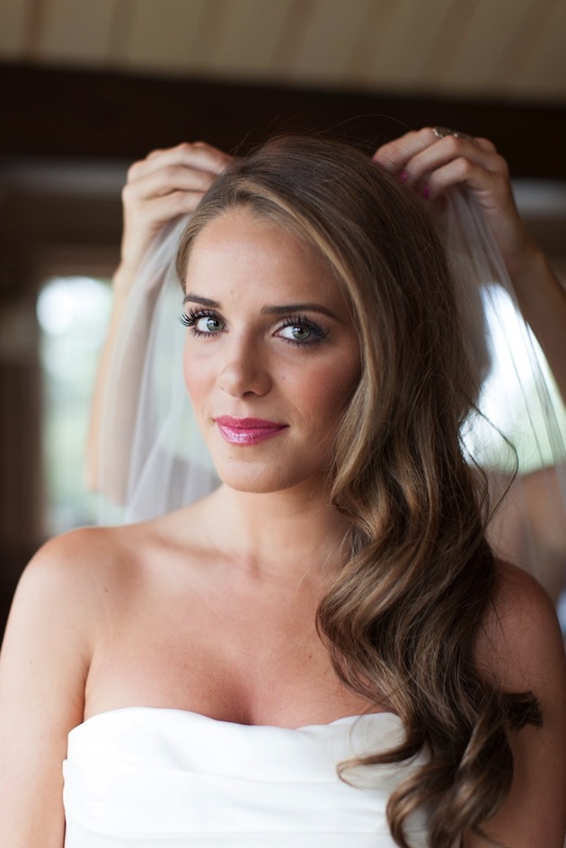 A girl in off shoulder dress  showing her Side Swept Curl - bridal hairstyles