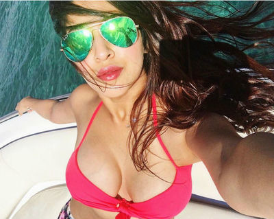 Sonarika Bhadoria in red bikini and googles posing for a selfie in a boat - most beautiful Indian girl