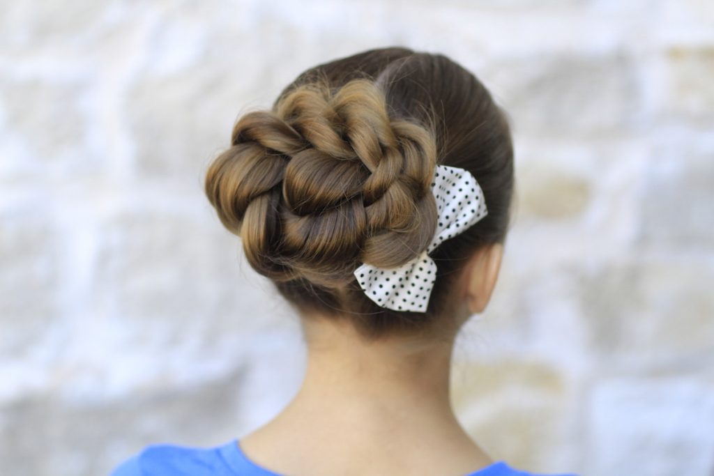 Woman in blue top with Twisted Bun -  hair cutting style for female with name