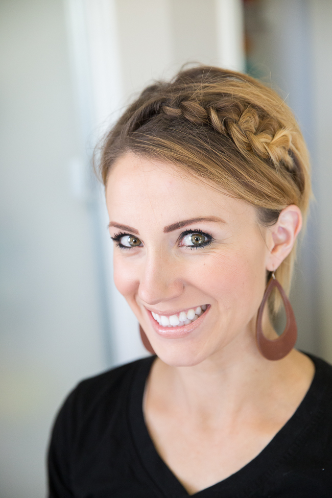 Smiling woman in black t-shirt and drop earrings with Braided Pixie - hairstyles for girls with long hair