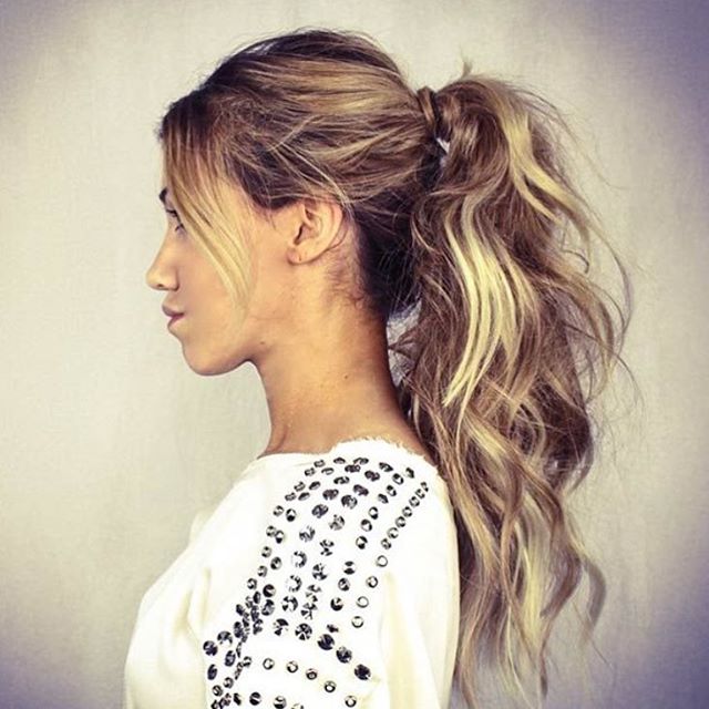 Woman in white top with silver beads and Fringed Ponytail Long Hair - best hairstyle for girl with long hair