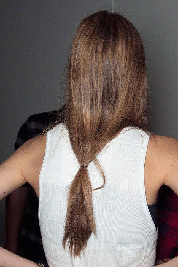 Woman in white cut sleeves top and Loose Ponytails - hairstyle for long hair party