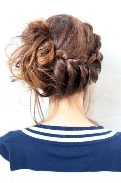 A girl in blue t-shirt with white strips showing the back view of her Classy Chignon - haircut Teenage Girls