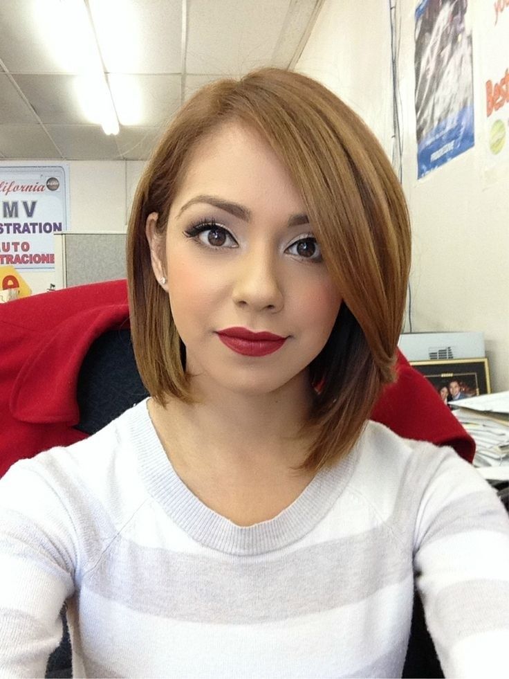 A girl in grey and white lining top with maroon lipstick showing her Short bob to long bob - latest haircuts for teenager girls