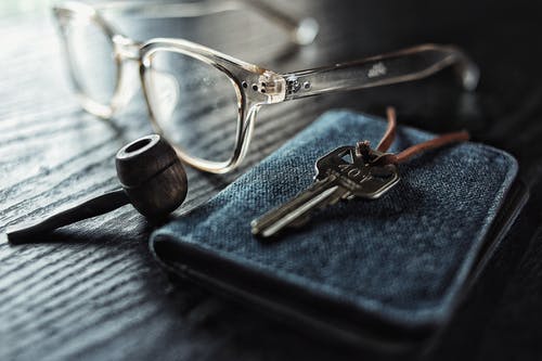 selective focus photo of silver key beside brown