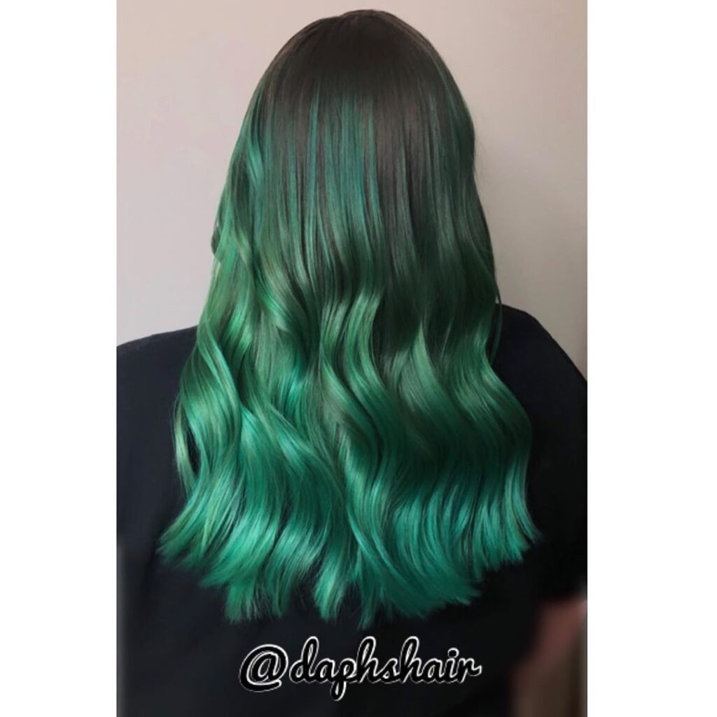 A girl in black t-shirt showing the back view of her kelly green hair color A girl in black t-shirt showing the back view of her kelly green hair color - hair color for long hair