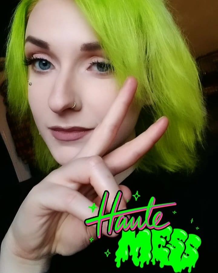 A girl is posing for camera and showing her  neon green hair color -  green hair color ideas