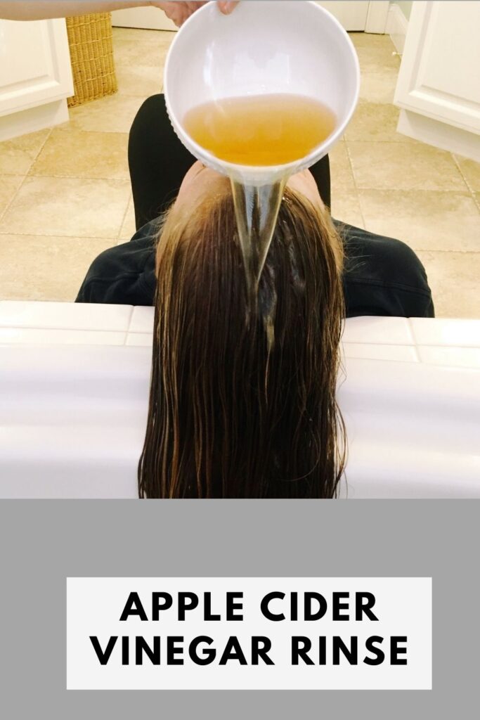 A lady is rinsing her hair with apple cider vinegar - how to make hair grow faster 1 week