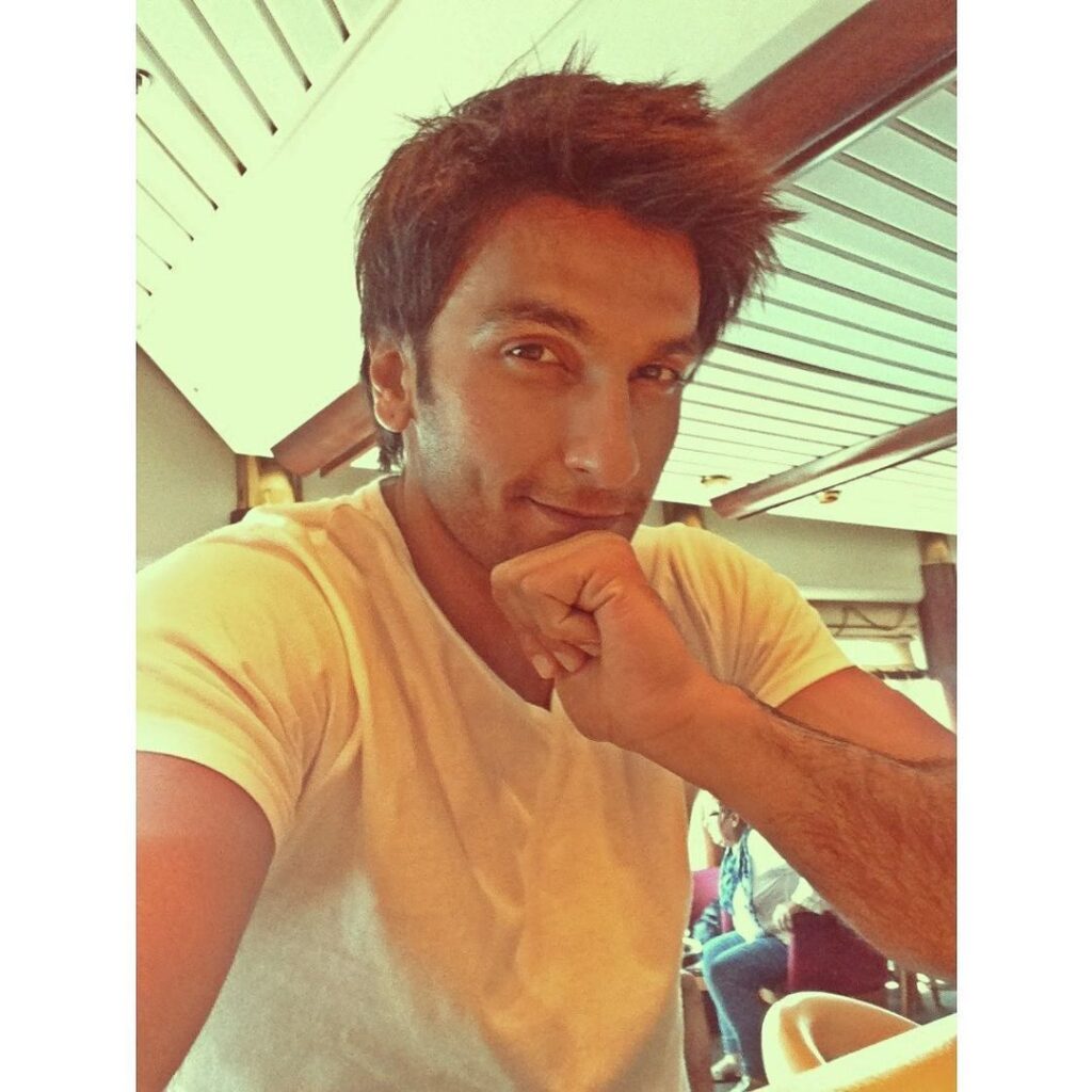 Smiling Ranveer Singh posing for a happy selfie in his Wavy Spikes - Ranveer Singh hairstyles 2021