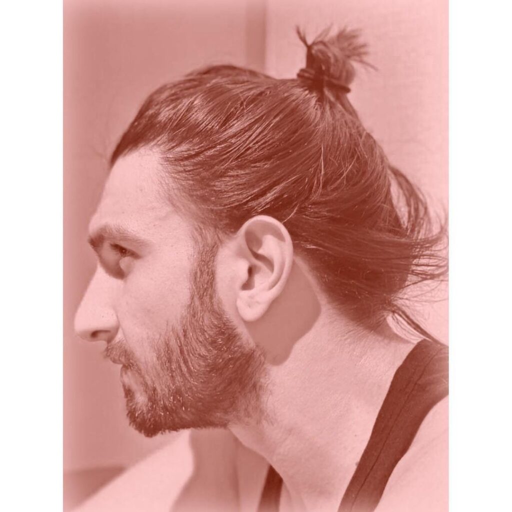 Ranveer Singh giving a side pose and showing his messy bun - Ranveer Singh Big Hair style