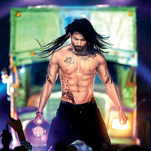 Shirtless shahid kapoor with tattoos all over the upper body showing his famous tommy singh hairstyle - shahid kapoor hairstyle pic 