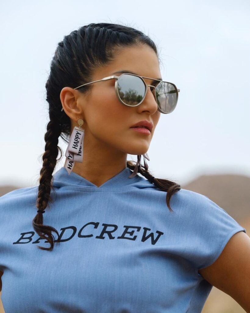 Sunny Leone in a funky blue t-shirt and side braid - Sunny Leone Latest hairstyle