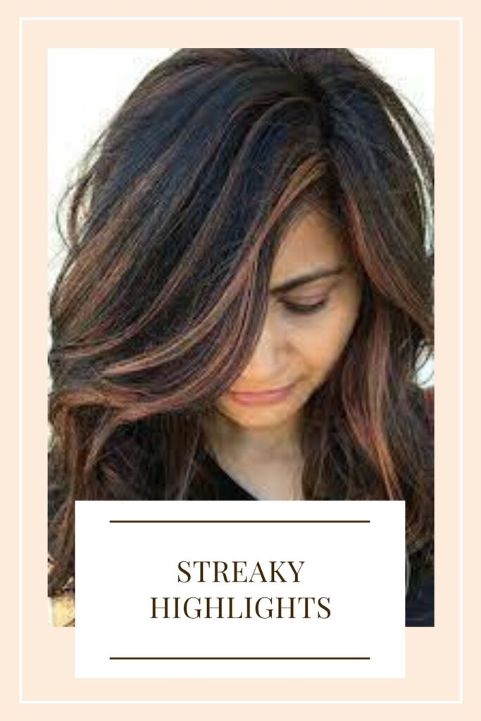 A girl is showing Streaky Highlights hair color - Hair color trends 2021 for short hair