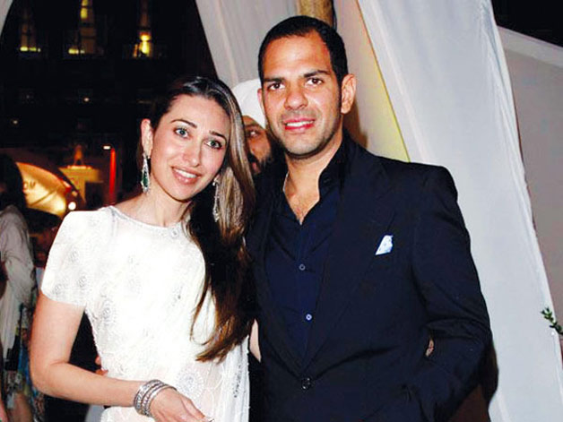 Karishma Kapoor in white saree and Sanjay Kapur in blue suit smiling - famous celebrity divorce list