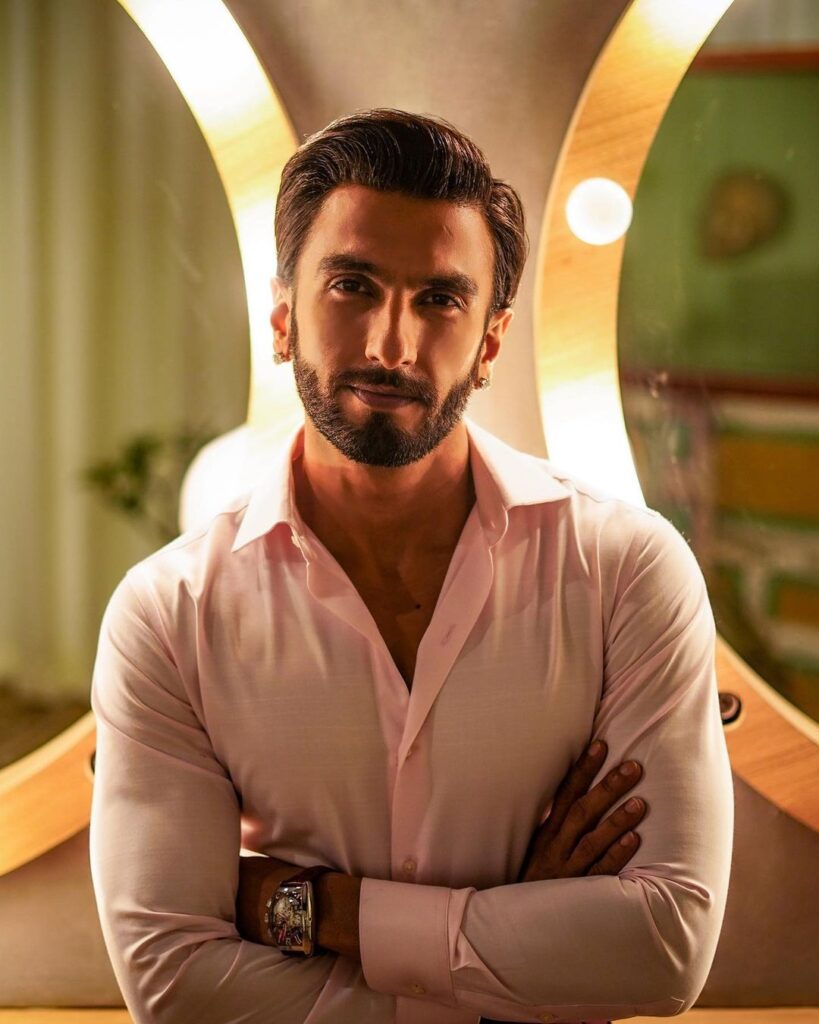 smiling Ranveer Singh posing in pink shirt -  bollywood handsome actors